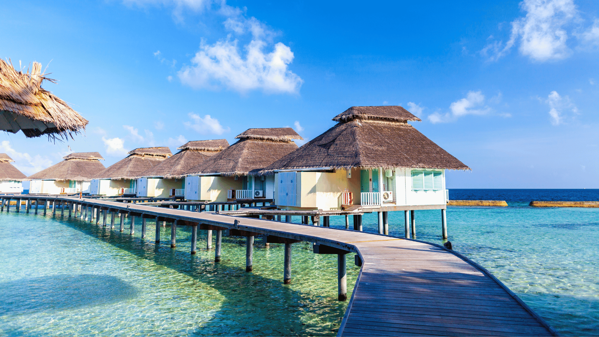 Luxury overwater villas surrounded by turquoise water